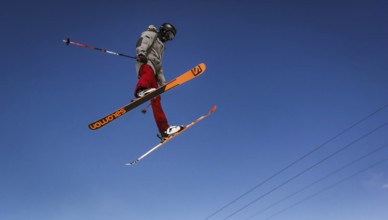 Skier jumping on a snow park in Austrian alps