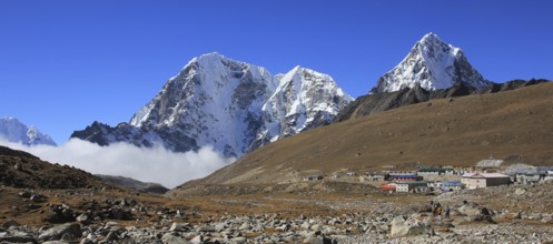 Huts in Lobuche and snow covered mountains Tobuche, Taboche and Cholatse, Nepal, Asia