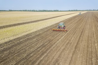 Farmer seeding crops at field. Seeding Aerial View