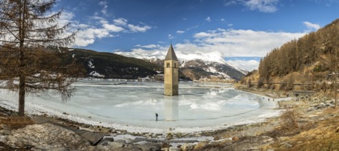 Panorama shot of flooded church tower in Lake Reschen (Reschensee) in South Tyrol, Italy, Europe