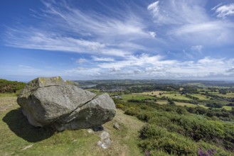 Large rock on a hill with sweeping views over a green landscape around Conwy and Conwy Castle on