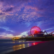 Santa Monica California sunset on Pier Ferrys wheel and reflection on beach wet sand