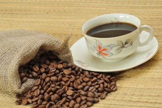 Coffee beans next to a coffee cup. Freshly ground coffee, Coffee beans next a coffee cup. Freshly