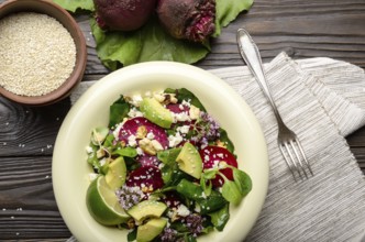 Top view at mediterranean roasted beet salad with avocado walnuts feta cheese oregano and mash