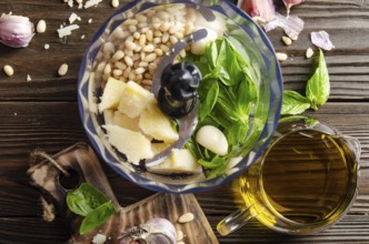 Ingredients for italian national traditional genovese pesto sauce in food processor bowl. Flat lay