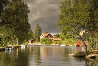 Dark sky over the Sundbornan river in the Swedish village Sundborn in the province Dalarna