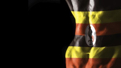Uganda flag on abs muscles national sport workout, bodybuilding concept, black background