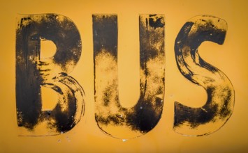 Aged Old Worn And Weathered Yellow Sign For A Bus