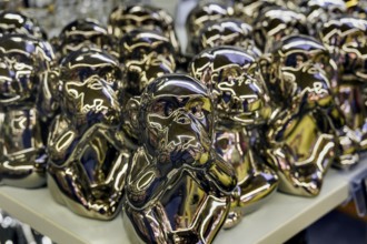 Monkey figures covering their mouths, a symbol of hearing, seeing and saying no evil, have become