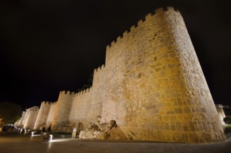 Night scene of famous Avila city walls in Castilla y Leon, Spain, Europe