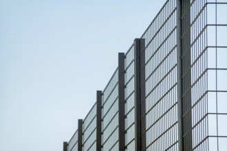 Large metal fence with sky