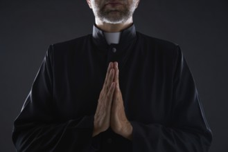 Praying hands priest portrait of male pastor