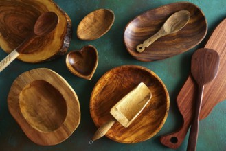 Wooden tableware on grungy green background