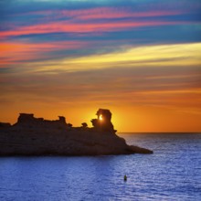 Menorca sunset in Cala Morell at Ses torretes beach Balearic Islands