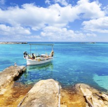 Els Pujols beach in Formentera with traditional fishing boat in summer day