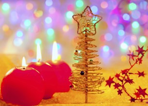 Christmas golden tree with baubles and candles in blur lights