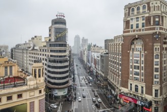 Madrid, Spain, November 20, 2016: Rainy day in Gran Via in Madrid. It is an ornate and upscale