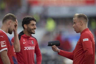 Football match, Eren DINKCI SC Freiburg centre laughing in conversation with former colleague