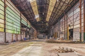 Large abandoned factory building with open roof and metal supports, The Galvanising Shop, Lost