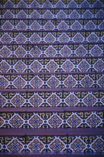 The steps of a staircase decorated with colourful oriental patterned tiles