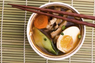 Ramen egg noodle soup dish with salmon fish