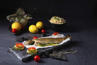 Baked trout with herb filling and tomatoes
