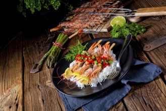 Grilled red argentine shrimps with red salsa and green asparagus