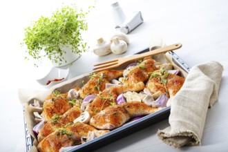 Prepared chicken legs with various vegetables and herbs