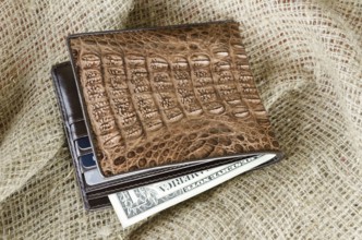 Wallet made ??of genuine crocodile leather over the linen background