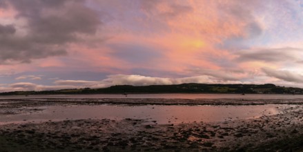 A panorama view of the Clyde River near Dumbarton at low tide at sunset