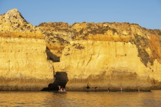 Stand-up paddler at Ponta de Piedade, Lagos, Algarve, Portugal, Europe
