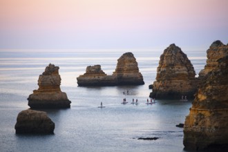 SUP paddlers at Praia Dona Ana, Lagos, Algarve, Portugal, Europe