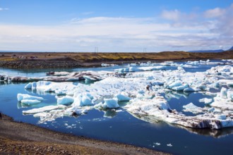 White-blue ice is piled up in turquoise water of Jokulsarlon. The concept of extreme northern