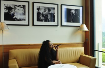 A Brazilian woman enjoys smoking a cigar in the Miles Davis Smoker's Lounge of the Kulm hotel in St