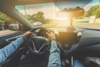 Close up of the driver holding the steering wheel while driving at high speed