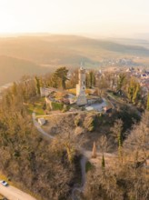 Aerial view of a castle ruin on a hill, surrounded by a village and bare trees, Löwenstein Castle,