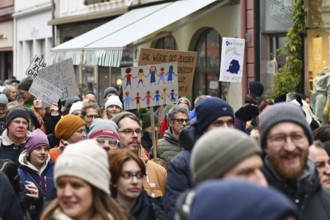 Heidelberg, Germany - February 12th 2025: Person holding up sign showing drawing of people of color