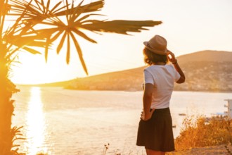 Panoramic view of the city and a tourist woman at sunset of Sarande or Saranda on the Albanian