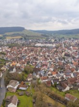 Aerial view of a town with red tiled roofs and surrounding hills on a cloudy day, Großbottwar,