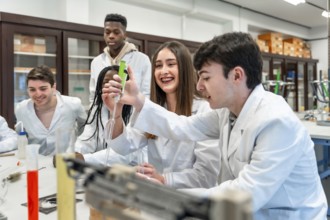 Diverse group of university chemistry students conducting an experiment in a lab, using lab coats