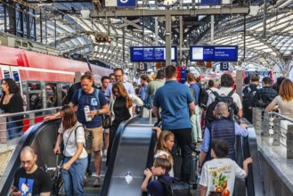 Cologne Central Station. Stairs to the platforms. Travellers waiting for their train on the