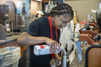 Detroit, Michigan - A young worker at a Starbucks coffee shop at Detroit Metro Airport