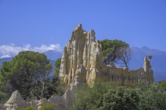 Sandstone cliff Les Orgues with Mount Canigou in the background, Ille-sur-Têt, Centre Ville