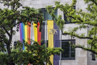 Rainbow flag next to the German flag and the flag of the state of Baden-Württemberg. Stuttgart,