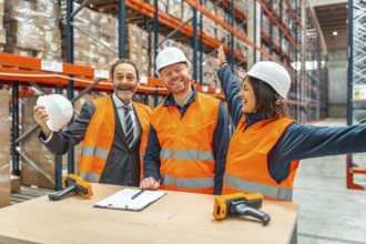 Warehouse workers and their manager are celebrating a successful logistics operation, expressing
