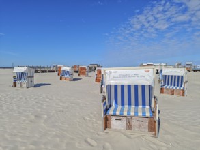Preparing for the high season on the beach, setting up the beach chairs, North Sea, on the edge of