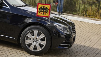 Black limousine with German flag parked outside, visit of Federal President Frank-Walter Steinmeier