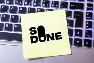 Notepad with the SO DONE logo on a laptop (composing) . SO DONE is a reporting portal specialising