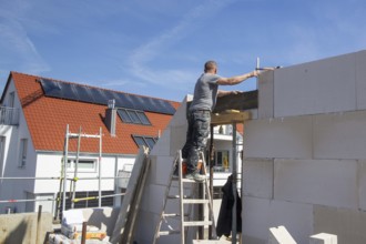 Bricklayer works on a new detached house