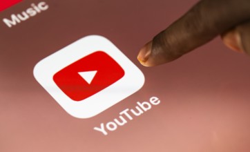 In this photo Illustration a person taps Googles Youtube application on a tablet device on 24 May